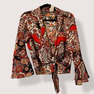 Ebuh cropped, tie front, wrap / blouse with bell sleeve. Polyester. Hand wash.